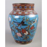 A large oriental Cloisonne enamelled vase. Decorated with birds amongst foliage designs on blue