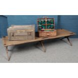 A WWII camp bed, together with ammunition box and picnic hamper.