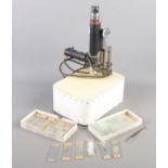 A Beck electric microscope along with a quantity of histology and similar slides.