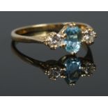 An 18ct Gold Aquamarine & Diamond three stone ring, in box with original sale receipt. Size P, Total