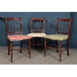 Three Mahogany spindle back dining chairs.
