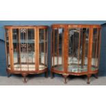 Two walnut mirror backed display cabinets.