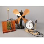 Three decorative table lamps. Includes cast iron fan, pressure gauge lamp/clock and a teak example