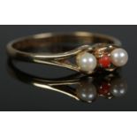 A yellow metal, coral and cultured pearl ring. Size NÂ½. Total weight: 1.8g.