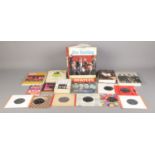 The Beatles: a quantity of books, together with a small selection of single records. Includes 'The