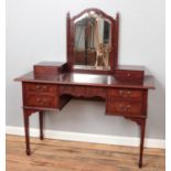 A yew wood dressing table on square tapering supports.
