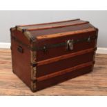 A vintage wood and metal bound steamer trunk. The lock stamped for Eagle Lock Co, USA.