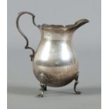 A silver helmet-shaped cream jug, assayed for London, by Charles Boyton & Son Ltd. Total weight: