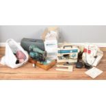 A quantity of sewing equipment. Including sewing machines, patterns, lace, etc.