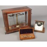 A Griffin and Tatlock voltmeter and chemist scales with weights.