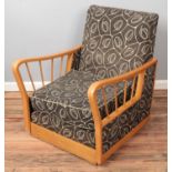 A mid-twentieth century beech framed metamorphic reclining chair/bed.