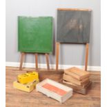 Two vintage easels/chalk boards along with a collection of wooden trays and concrete moulds.