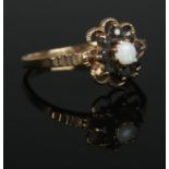 A 9ct Gold, Opal and Sapphire dress ring on stepped bridge. Size P. Total weight: 2.31g.