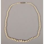 A string of cultured pearls with silver clasp. (46cm full length)