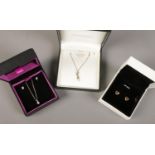 Three boxed pieces of gold and silver jewellery. Includes 9ct gold heart shaped earrings, 9ct gold
