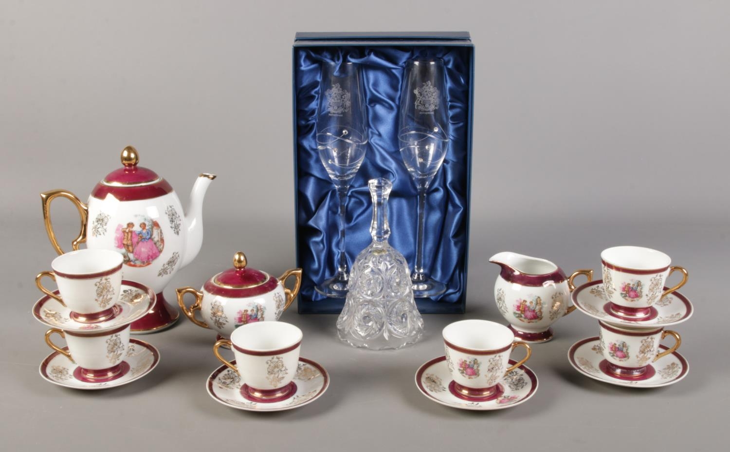 A pair of Diamante champagne glasses, with Rotherham crest, together with an oriental tea set,