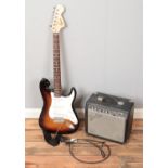 A Squier by Fender electric guitar along with a Fender amplifier.
