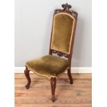 A carved rosewood hall chair. With green upholstery.