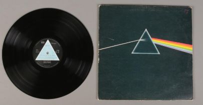 A Pink Floyd Dark Side of the Moon LP record, first pressing with solid light blue triangle label.