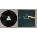 A Pink Floyd Dark Side of the Moon LP record, first pressing with solid light blue triangle label.