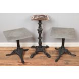 Two painted cast iron tables along with a similar taller table base example.