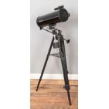 A Tasco telescope. On tripod stand.