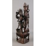 An extensively carved hardwood tribal figure group, depicting dancing girls. 53cm high.