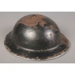 A WWII metal brodie helmet. Tint to the top.