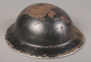 A WWII metal brodie helmet. Tint to the top.