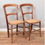 A pair of mahogany balloon back Bergere based chairs.