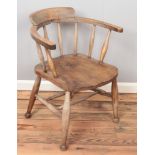 A carved oak smokers bow armchair.