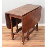 An oak drop leaf gateleg table. (Height 74cm, Width 91cm, Extended length 120cm).