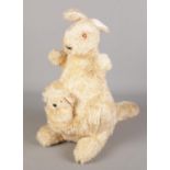 A large kangaroo soft toy with baby in pouch.