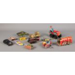A collection of vintage tin-plate toys, to include wind up clockwork examples and Schuco Kommando