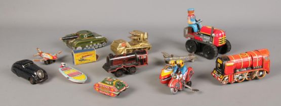 A collection of vintage tin-plate toys, to include wind up clockwork examples and Schuco Kommando