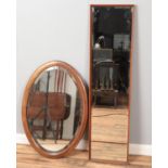 A bevel edged oval wall mirror with inlaid decoration along with a bevel edged rectangular example.