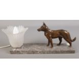 An Art Deco table lamp with marble base and mounted bronzed Alsatian dog.