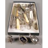 A tray of flatware along with a silver plated cruet set.