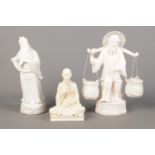 Two Blanc De Chine ceramic figures of a water carrier and elder, together with a similar composite