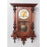 A mahogany cased wall clock. With Arabic numeral markers, chiming on a coiled gong. With pendulum