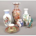 A quantity of oriental ceramics, to include cup and saucer trio, lidded ginger jar and large vases.