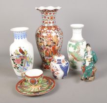 A quantity of oriental ceramics, to include cup and saucer trio, lidded ginger jar and large vases.