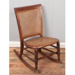 A mahogany and bergÃ¨re rocking chair.