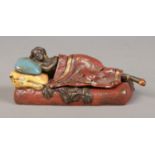 In the style of Franz Bergmann (1861-1936), a cold painted bronze figure of a woman lying on a