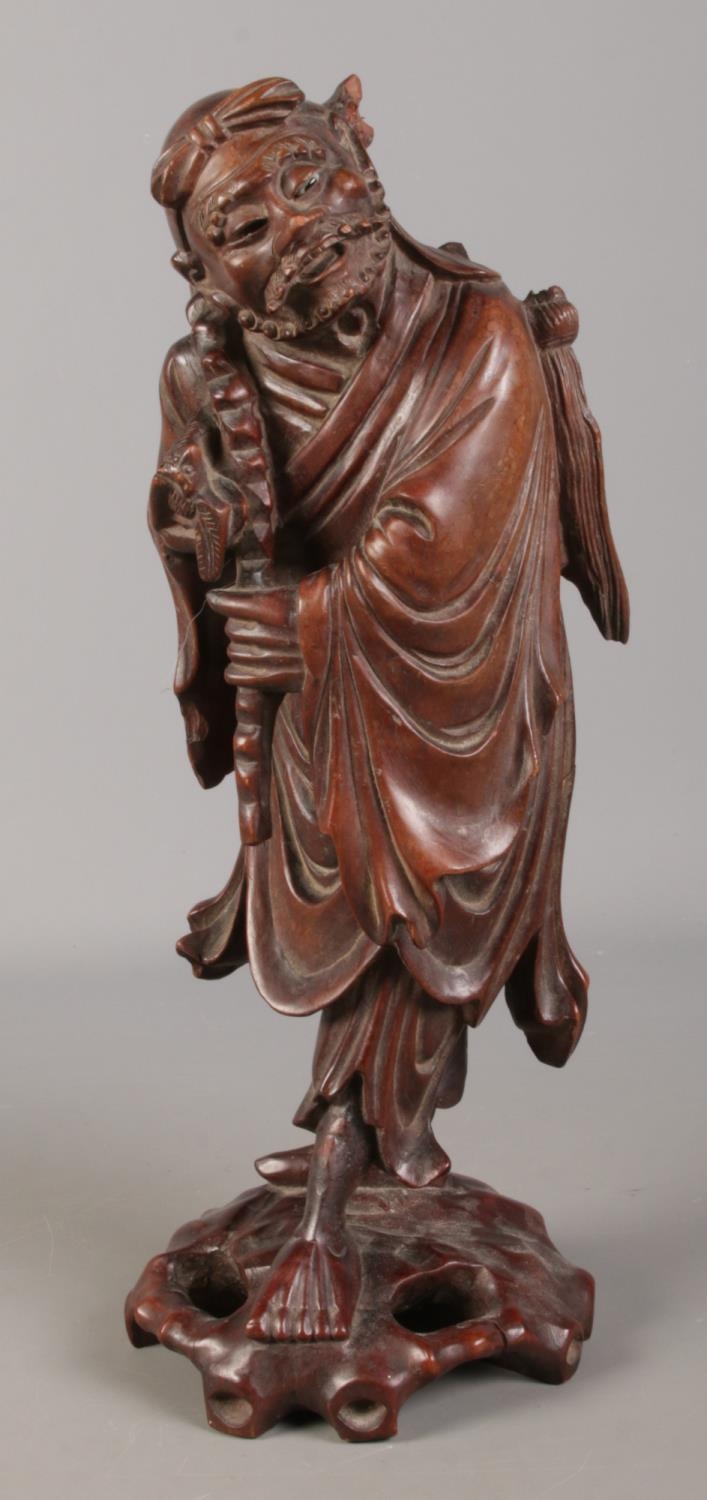 A Chinese carved hardwood figure. 39cm high. Damaged. One eye missing, piece missing from top,