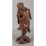 A Chinese carved hardwood figure. 39cm high. Damaged. One eye missing, piece missing from top,