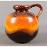 A large West German handled lava vase, shape 484-21, in brown and orange/red. Height: 22cm, Width:
