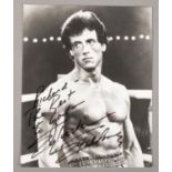 An autographed monochrome photograph of Sylvester Stallone.