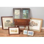 A carved oak portfolio stand along with a pair of early 20th century framed oils and five prints.