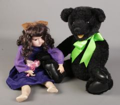 A black limited edition Gund jointed bear along with a Diamond & Co bisque doll.